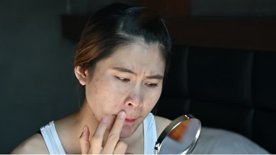 Woman Checking Nose Hair Before Bed - Fix Nose Hair Safely with Best Low-Light Nose Hair Trimmer