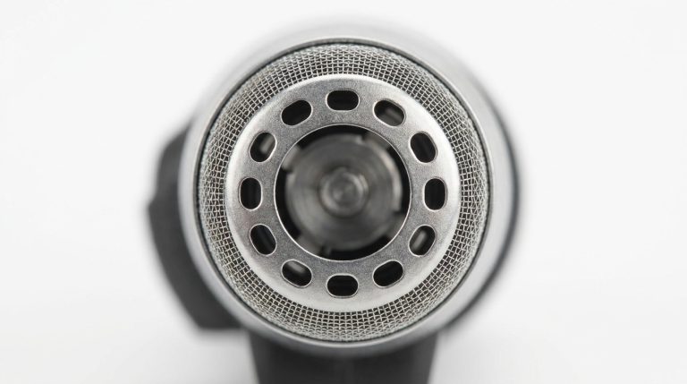 Close-up of nose hair trimmer protective guard showing blade clearance — rounded rotary head design for safe senior use